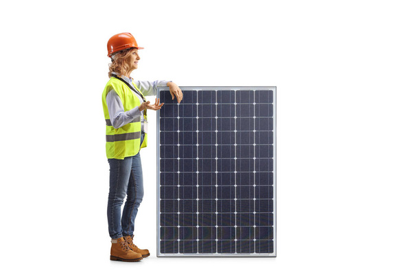 Female engineer explaining about a solar panel isolated on white background - Photo, image