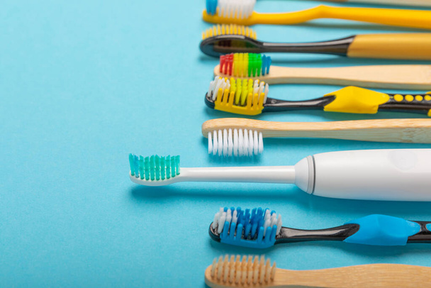Electric, bamboo and ordinary toothbrushes on a colored background. Oral hygiene. Eco. Prevention of caries. Dental car. The concept of dentistry and eco-friendly lifestyle.Place for text. - Photo, Image
