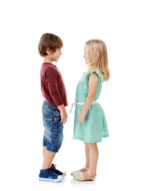 Will you be my best friend. Studio shot of a cute little boy and girl standing face to face against a white background - Foto, Imagem