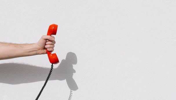 hand holding Red telephone receiver with copy space - Photo, Image