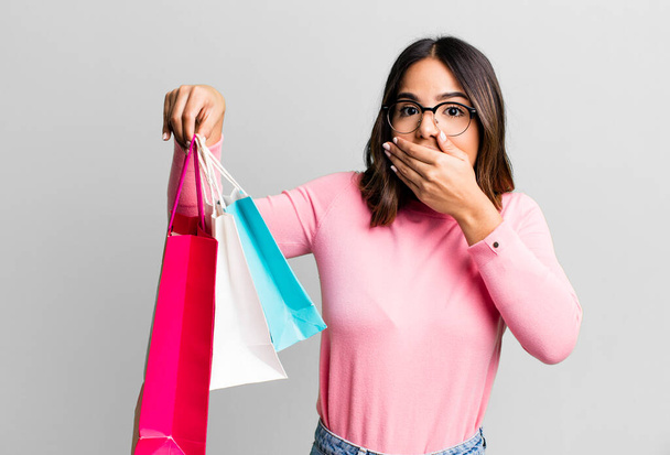 hispanic pretty woman covering mouth with hands with a shocked. shopping concept - Foto, imagen