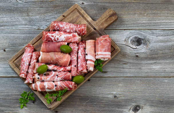Various raw meats on rustic serving board  - Photo, Image