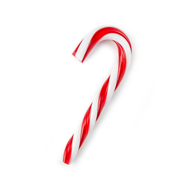bastón de caramelo rayado en colores navideños aislado en una espalda blanca - Foto, Imagen