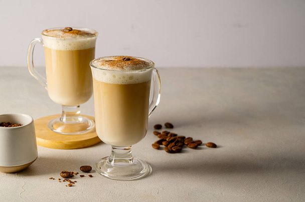 Two cups with coffee drink, latte or mocha with milk foam and cinnamon. - Φωτογραφία, εικόνα