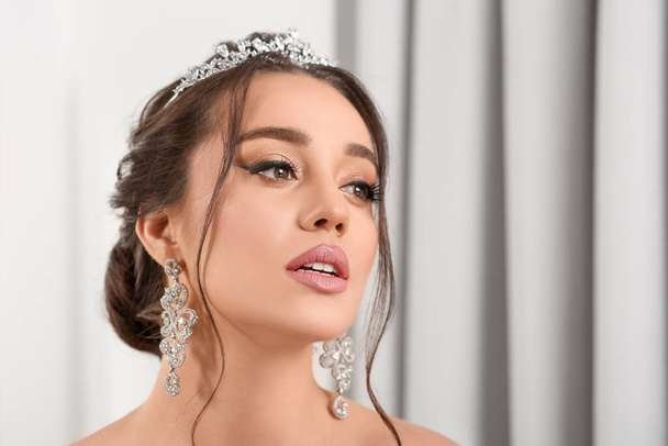 Beautiful young woman wearing luxurious tiara indoors. Space for text - Фото, зображення