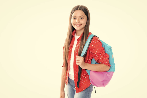 Back to school. Teenager schoolgirl in school uniform with bagpack. School children on isolated studio white background. Portrait of happy smiling teenage child girl - Foto, Imagem