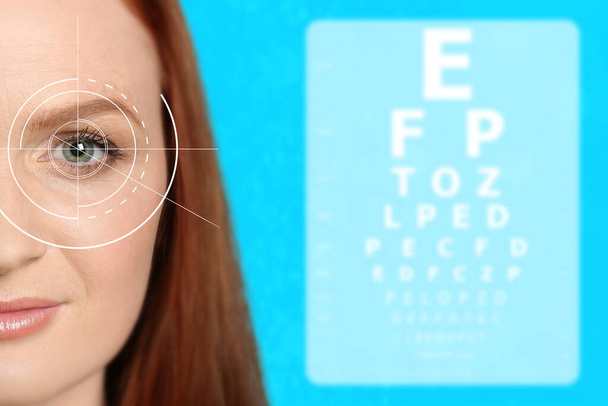 Vision test. Woman and eye chart on light blue background - Fotografie, Obrázek