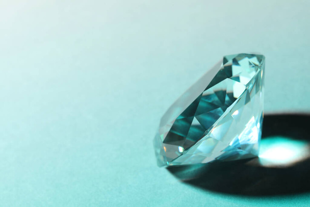 Beautiful dazzling diamond on light background, closeup. Space for text - Foto, Imagem