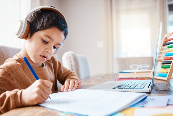 Learning headphones, math education and child in home with book for studying, homework or homeschool. Development, laptop or boy or kid with notebook for numbers in elearning, virtual or online class. - Fotoğraf, Görsel