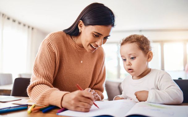 Learning, education and mother with kid drawing in book in home for studying, homework or homeschool. Early development, growth and creative boy with happy mama teaching him art, bonding and care - Foto, Imagem