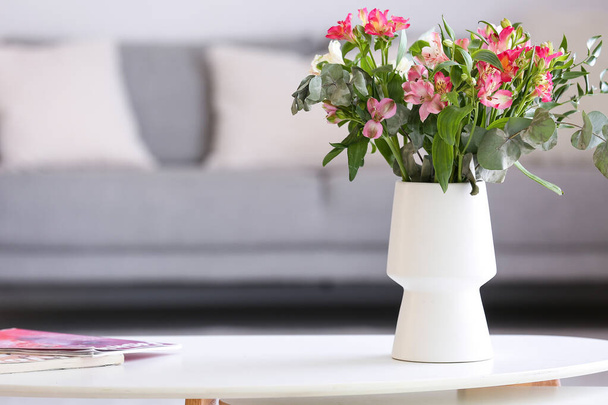Vase with beautiful alstroemeria flowers on table in room - Valokuva, kuva