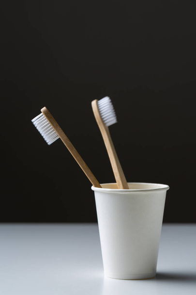 Toothbrush in a cardboard ecological cardboard cup, hygiene health care. - Foto, afbeelding