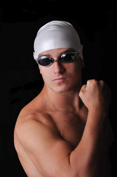 Male swimmer isolated in black - Foto, afbeelding
