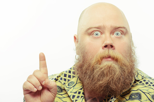 Surprised bearded man pointing up - Photo, image