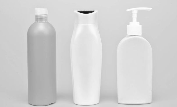 Wonderful daily necessities for you. Plastic packaging bottles. Cosmetic bottles yellow background. Toiletry packing. Liquid containers. For bath and shower products, copy space. - Foto, afbeelding