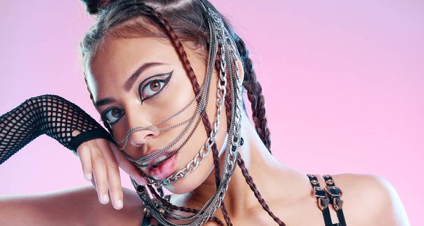 Black woman, bdsm portrait and chain mask with metal, rock or punk aesthetic by pink background. Gen z model, sexy and grunge with trippy, psychedelic and creative with steel jewellery, face and mask. - Photo, image