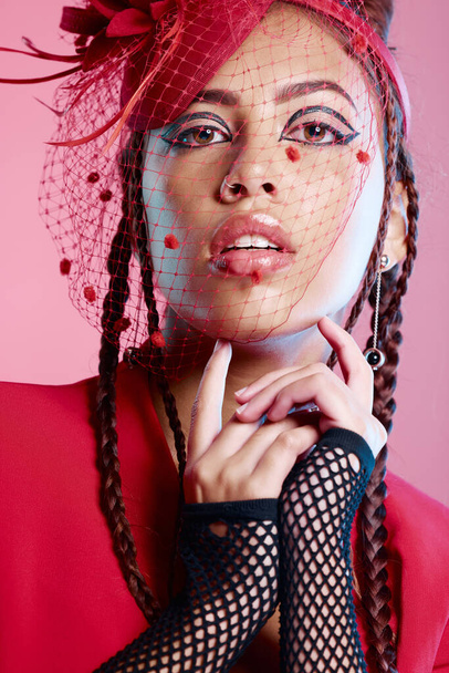 Punk, rock and portrait of a young woman with creative designer, fashion and edgy clothing. Isolated, pink background and gen z latino model beauty with cool, rocker and funky style in a studio. - 写真・画像