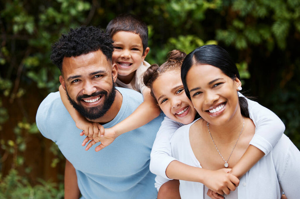 Happy, carefree and fun family playing, bonding and enjoying a day in a nature park together on the weekend in summer. Portrait of the faces of cheerful, caring and loving children hugging parents. - Foto, Imagen
