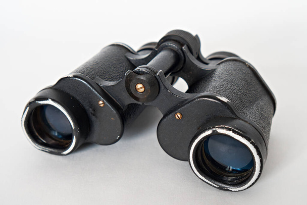 Black vintage binoculars isolated on white background. - Foto, imagen