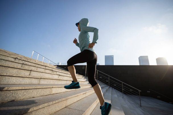Fitness sports woman running up stairs in city - Foto, Imagem