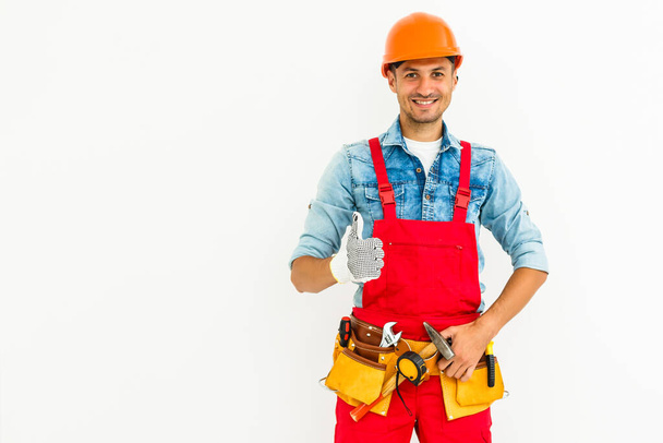 Young construction workers with hard hats on a white background. - Photo, Image