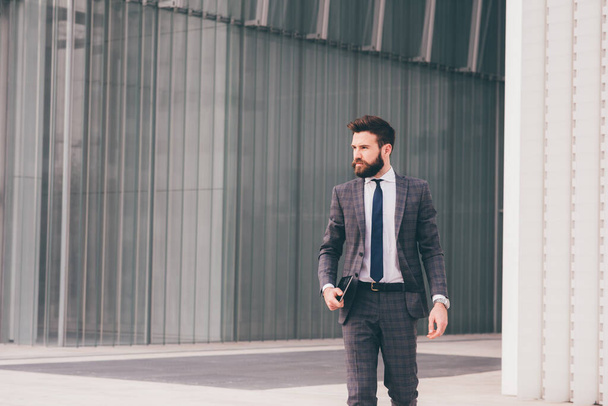 Confident and professional elegant bearded businessman walking outdoor strong and trusty - Foto, immagini