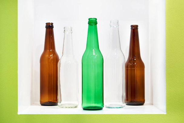 Empty bottles for alcoholic drinks at a shop window - Фото, зображення