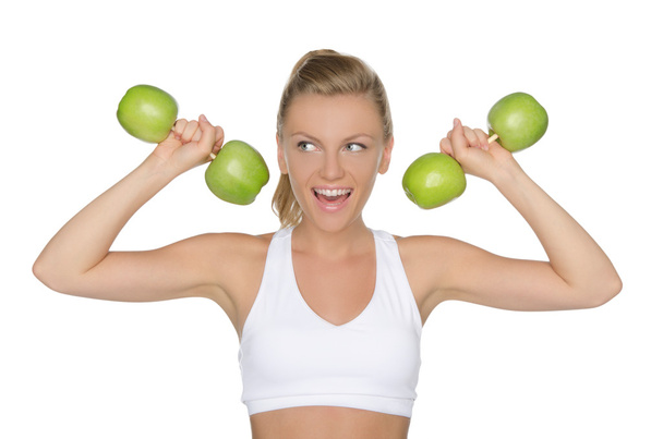 woman with dumbbells from apples looking away - Fotoğraf, Görsel