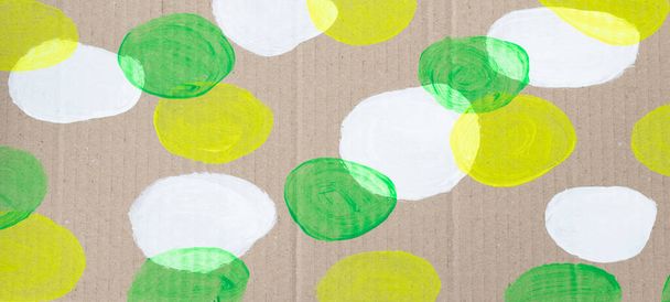 Cardboard with a pattern of round white, green and yellow neon spots - Photo, Image
