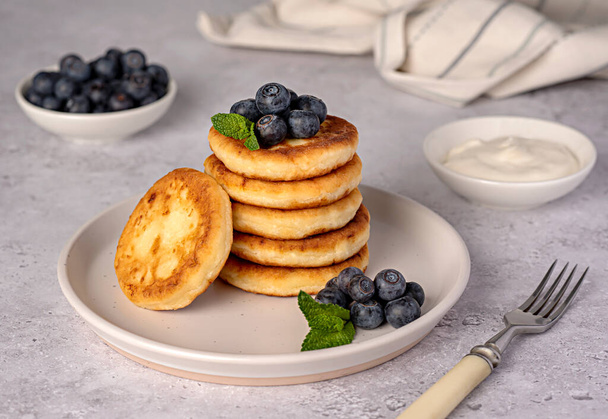 Food photography of pancakes, cottage cheese, blueberries, cream, breakfast; brunch, mint, morning - Valokuva, kuva