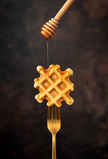 Macro food photography of waffle, fork, honey, breakfast, belgian, snack, dessert, sweet, crispy - Fotoğraf, Görsel