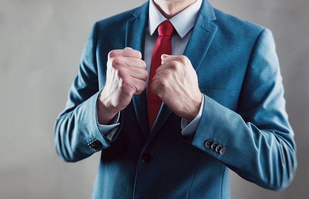 businessman raising fist and celebrating victory with hands - business gesture and people concept image - Foto, imagen