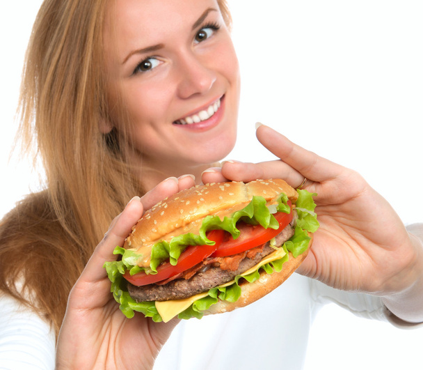 Woman showing tasty unhealthy burger sandwich - Photo, image