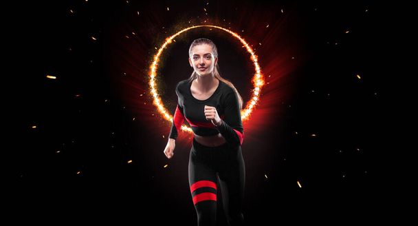 Sprinter run. Strong athletic woman running on black background wearing in the sportswear. Fitness and sport motivation. Runner concept - Zdjęcie, obraz