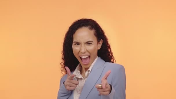 Face, laughing and business woman pointing to you in studio isolated on an orange background. Comic, emoji and smile of happy female professional gesturing for winner, decision or success choice - Video, Çekim