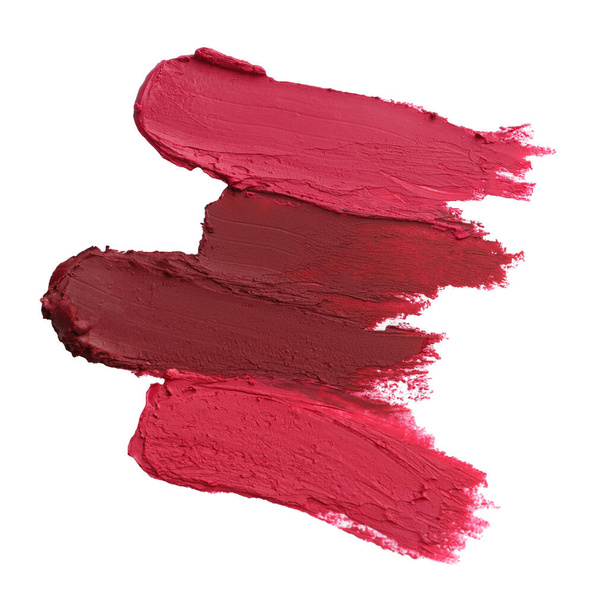 Smears of bright lipsticks on white background, top view - Foto, imagen