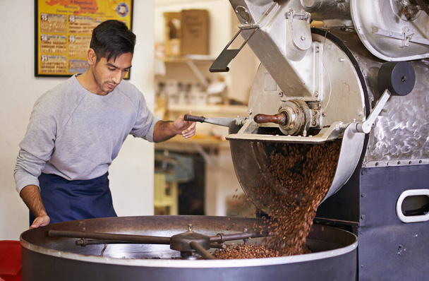 Master of coffee. a machine grinding and roasting coffee beans - Photo, Image