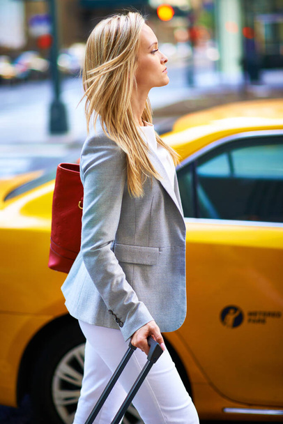 Отпуск в моде. Красивая женщина гуляет по городу со своим багажом - Фото, изображение