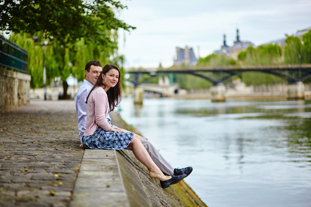Couple is sitting on the embankment - Foto, immagini