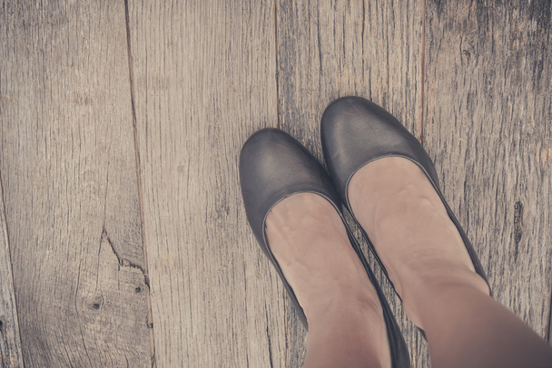 Feet. First-Person view  on rustic wood background. - Photo, Image