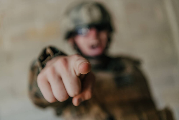 I choose you. A soldier with an outstretched hand towards the camera shows that he chooses you for support and partnership in warfare. - Фото, изображение