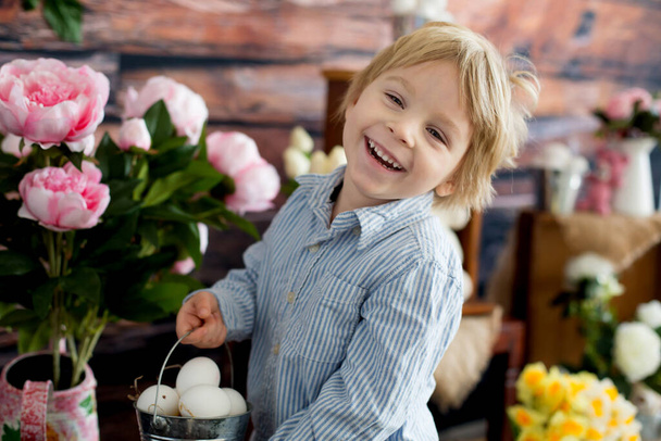 Cute toddler blond child, boy with easter decoration in studio - Foto, immagini