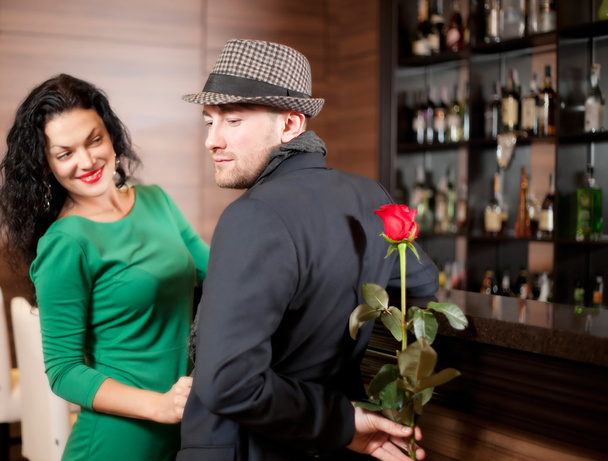 Man with a flower in a hand and the fine girl in cafe - Foto, imagen