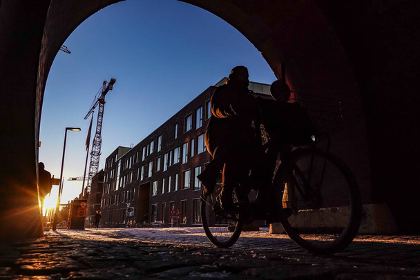 Kopenhagen, Dänemark Ein Radfahrer im alten Carlsberg-Brauereiviertel im Morgengrauen. - Foto, Bild