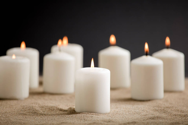 candles with burning flame, in the sand - Photo, Image