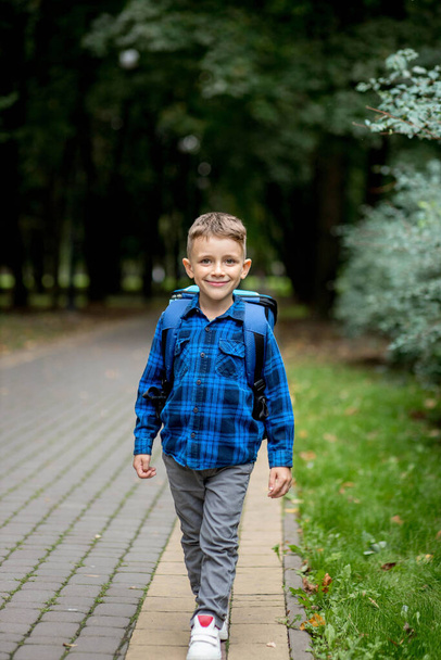 Portrait of a first grader with a backpack. The boy goes to school. - Foto, immagini