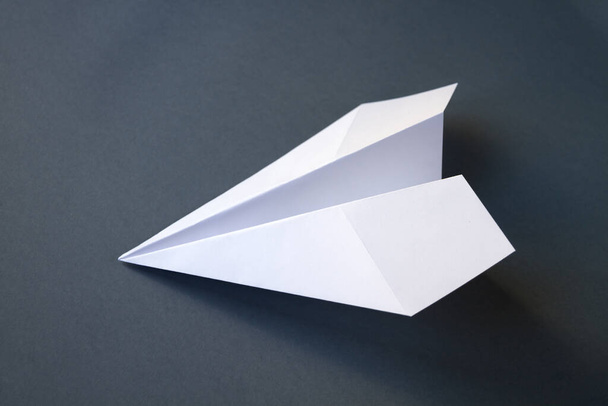 White paper plane origami isolated on a blank grey background - Zdjęcie, obraz