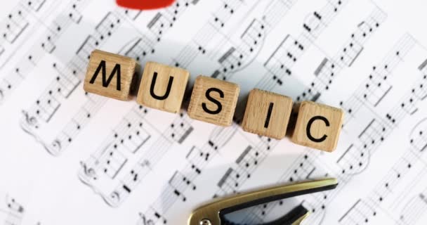 Palabra musical de cubos de madera y notas musicales. Artes musicales y enseñanza - Imágenes, Vídeo