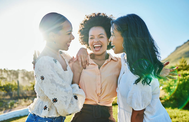 Friends, happy and women hug outdoor in nature, travel and adventure with lens flare, day out in the sun for summer holiday. Happiness, care and together with love and bonding on vacation in Brazil - Foto, Imagen