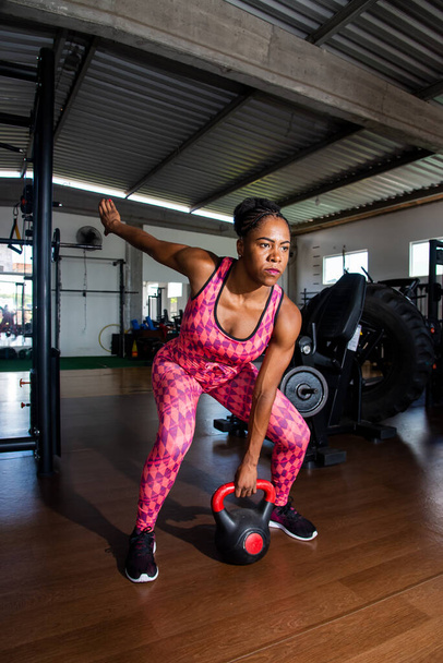 Determined Woman Doing Squat Exercises With Kettlebell. Spine strengthening. - Fotó, kép